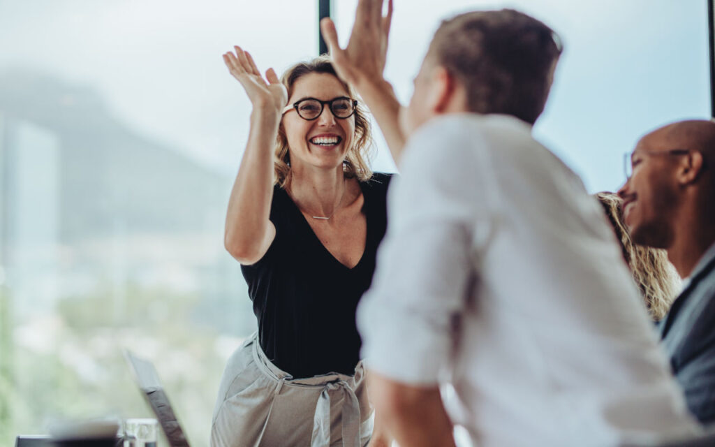 two employees do a high five