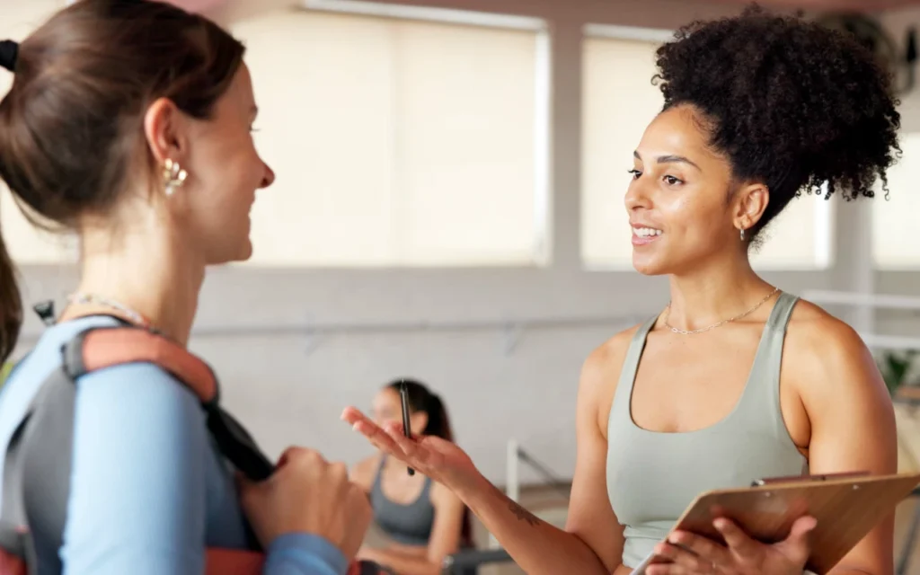 Two women at he gym supporting one-another
