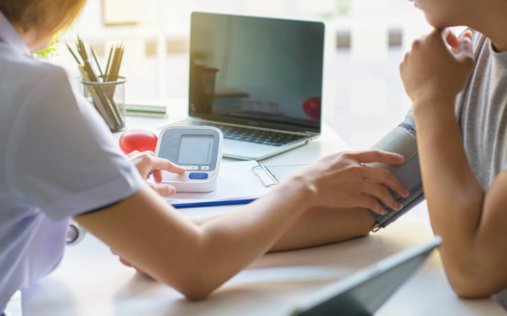 A physician measuring a patient's blood pressure