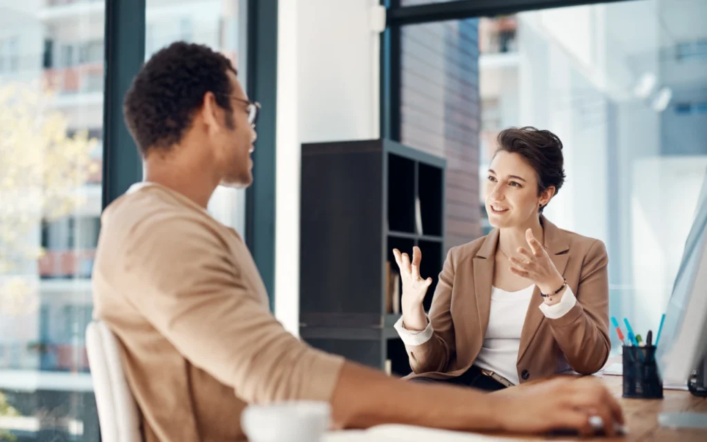Two colleagues talking in a board room
