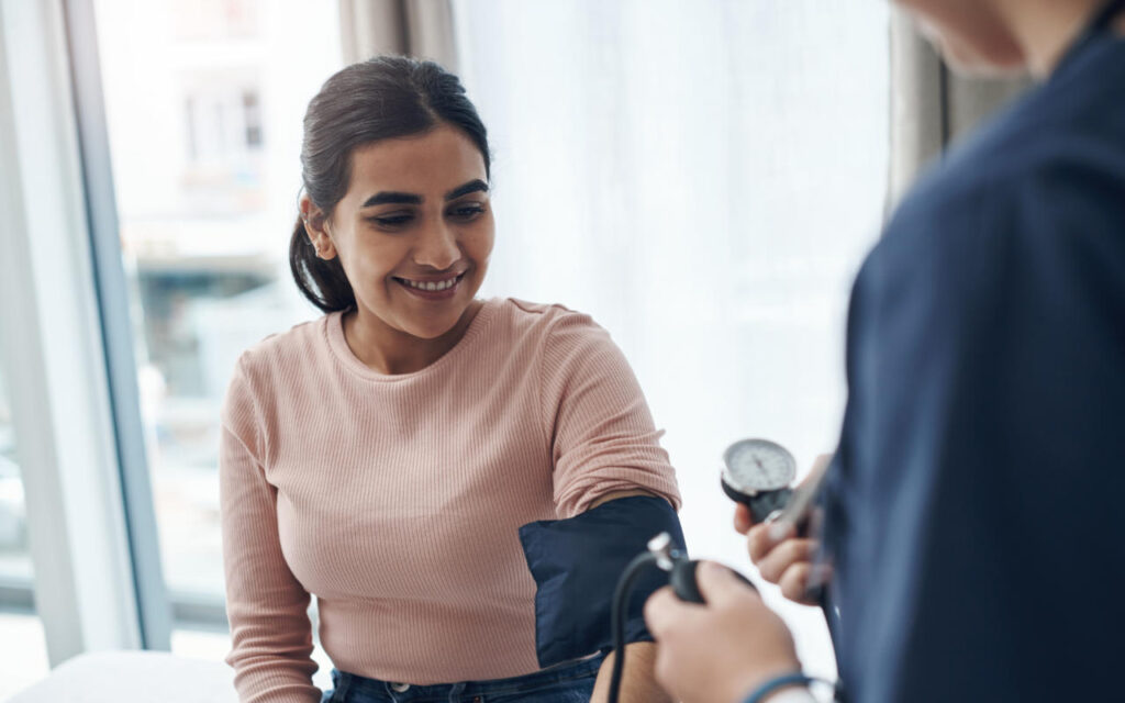 A woman having her blood pressure taken