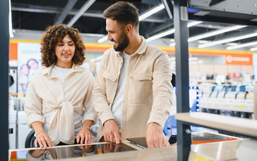 Couple purchasing white goods using retail discount
