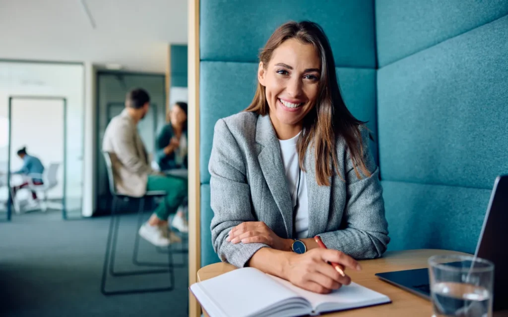 an employee asking for a reasonable adjustment at work, sat in an office booth.